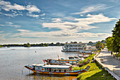 Dragon boats moored at the bank of Perfume River. Hue, Vietnam.