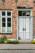  Green entrance to a brick house 