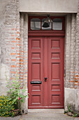  Entrance to a historic brick house with floral decoration 