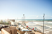  Rabat beach at high tide, with lots of surfers, high waves and at lunchtime in Rabat, Morocco. 