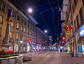 Beautiful Old City Street with Old Building and Flags in Dusk in City of Bern, Canton Bern, Switzerland.