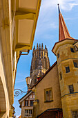 Cathedral Tower and House Tower in Old Town Medieval in a Sunny Summer Day in Fribourg, Canton Fribourg, Switzerland.