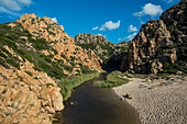  Red rocks and picturesque beach, Spiaggia di Cala li Cossi, Costa Paradiso, Sardinia, Italy 