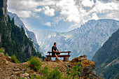  Hiker on park bench looks into the Tara Gorge in the Durmitor mountain range, natural landscape, landscape, Durmitor National Park, Montenegro 