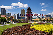  Flags at the Independence Monument in the city center with skyline behind, Phnom Penh, Cambodia, Asia 