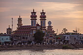  Cao Dai Temple on the Mekong River at sunset, Tan Chau, An Giang, Vietnam, Asia 