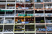  High-rise building with many advertising signs in the city center, Ho Chi Minh City, Vietnam, Asia 