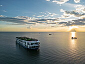  Aerial view of river cruise ship RV Mekong Discovery (Thurgau Travel) on Tonle Sap Lake at sunset, Chong Khnies, near Siem Reap, Siem Reap Province, Cambodia, Asia 