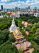  Aerial view of the hilltop temple Wat Phnom with skyscrapers in the distance, Daun Penh District, Phnom Penh, Cambodia, Asia 