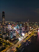  Aerial view of rush hour traffic along Saigon River with skyscrapers in downtown District 1 at night, Quan 4, Ho Chi Minh City, Vietnam, Asia 