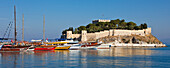 Boats moored at pier near the Castle on Pigeon Island. Kusadasi, Aydin Province, Turkey.