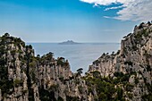  View over rocks to island in the Mediterranean Sea in the Cassis region, coasts, cliff, Mediterranean Sea, limestone, Calanques National Park, France, Southern France\n 