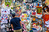  Man looking at graffiti art in central London, City Center, UK, Great Britain, \n 