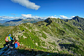  Man and woman hiking on the GTA looking at Monte Mars, Colma di Mombarone, GTA, Grande Traversée des Alpes, Biella, Alpi Biellesi, Valais Alps, Piedmont, Italy 