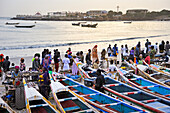 Sellers and fishing dugout boats at Soumbedioun, Dakar,Senegal, West Africa