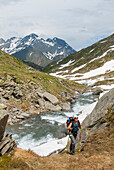 Hiker by the Reno di Medels river,Val Piora,Canton Ticino,Switzerland,Europe