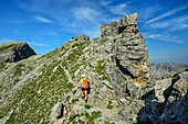  Man mountaineering ascends to Knittelkarspitze, Reuttener Höhenweg, Lechtal Alps, Tyrol, Austria 