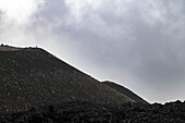  View of secondary crater of Mount Etna, man standing on crater rim, Silvestri crater, Piccolo cratere sud dell&#39;Etna, UNESCO World Heritage volcano, stratovolcano, Mount Etna, Italy, Sicily,\n 