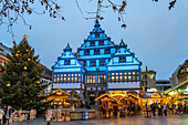  Christmas market at the colorfully illuminated Paderborn town hall at dusk in Paderborn, North Rhine-Westphalia, Germany, Europe 