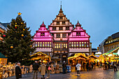  Christmas market at the colorfully illuminated Paderborn town hall at dusk in Paderborn, North Rhine-Westphalia, Germany, Europe 