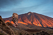  Panorama at sunrise of the Roque Chinchado, also known as the Stone Tree or Finger of God, landmark of the island, Los Roques de Garcia, behind it the Pico del Teide, 3717m, Las Cañadas, Teide National Park, Tenerife, Canary Islands, Spain, Europe 