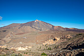  Panorama during the ascent to the Alto de Guajara, 2715m, to the bizarrely shaped rock formations made of volcanic rock, Roques de García, the visitor center and the Hotel Parador, behind it the Pico del Teide, 3717m, at sunrise, Teide National Park, Parque Nacional del Teide, Tenerife, Canary Islands, Spain, Europe 