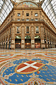 Ornate floor mosaic in the Vittorio Emanuele II Gallery, Italy's oldest active shopping gallery and a major landmark. Milan, Italy.