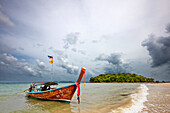 Traditional Thai long-tail boat moored at Klong Muang Beach. Krabi Province, Thailand.