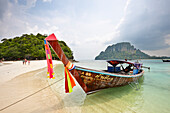 Traditional Thai long-tail boat moored at the beach on Tup Island, aka Tub Island, Koh Tap or Koh Thap. Krabi Province, Thailand.