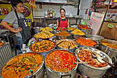 A selection of freshly cooked traditional Thai dishes displayed on a food stall at Or Tor Kor (OTK) Fresh Market. Bangkok, Thailand.