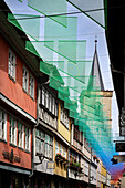 Colorful half-timbered houses with small shops decorate the Krämerbrücke, view through art installation to the church tower of the Krämerbrücke, Erfurt, state capital, Free State of Thuringia, Germany, Europe