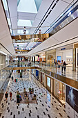 People walk inside Exchange TRX, an upscale shopping mall in Kuala Lumpur, Malaysia.