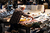 A man preparing fish for sale in Athens central Market, Greece