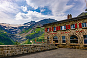 Terrace and Restaurant View over Beautiful Mountain Alp Grüm with Glacier and Alpine Lake Palü in a Cloudy Summer Day in Poschiavo, Bernina, Grisons, Switzerland.