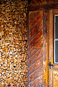 Beautiful House Door Enzrance with Firewood in a Summer Day in Samedan, Grisons, Switzerland.