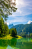 Beautiful Alpine Lake Preda, Lai da Palpuogna in a Mountain Valley in the Swiss Alps in a Sunny Summer Day with Blue Sky and Clouds in Albula, Bergün, Filisur, Grisons, Switzerland.