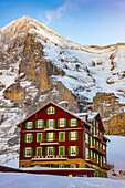 The Famous and Historical Hotel Bellevue des Alpes at 2061 Meters High Up and Mountain Peak of North Face of Eiger 3907 Meter High in a Sunny Winter Day in Kleine Scheidegg, Grindelwald, Canton Bern, Switzerland.