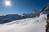Beautiful Aletsch Glacier in a Sunny Winter Day with Snowcapped Mountain with Sunbeam in Jungfraujoch in Berner Oberland, Grindelwald, Canton Bern, Canton Valais, Switzerland.