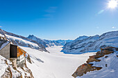 Beautiful Aletsch Glacier and Building in a Sunny Winter Day with Snowcapped Mountain with Sunlight in Jungfraujoch in Berner Oberland, Grindelwald, Canton Bern, Canton Valais, Switzerland.