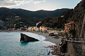 Blick auf Häuser, Felsen und Hügel bei Sonnenuntergang, Monterosso, Cinque Terre, Provinz La Spezia, Ligurien, Italien