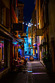 Shopping Street in Old Town with Illuminated House and Window in Dusk in City of Neuchatel, Canton Neuchatel, Switzerland.