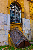 Cobblestone Street in Old Town with House and Window with Cellar Door in City of Neuchatel, Canton Neuchatel, Switzerland.