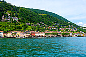 House and Mountain Range in a Sunny Summer Day on the Waterfront to Lake Lugano in Morcote, Lugano, Ticino, Switzerland.