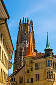 Cathedral Tower and House Tower in Old Town Medieval in a Sunny Summer Day in Fribourg, Canton Fribourg, Switzerland.