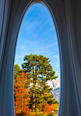 Beautiful Autumn Forest and an Arch Window and Mountain and Sky with Sunlight in a Sunny Day in Bad Ragaz, St Gallen, Switzerland.
