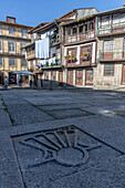  Old cobbled square with old houses in the background and laundry drying on the balcony, Braga, Guimaraes, Portugal 