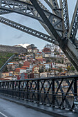  Bridge construction of the Ponte Dom Luis I and old town houses in the background on the banks of the Douro, Porto, Portugal 