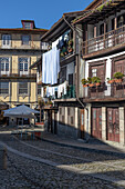  Old house facade with balcony and laundry drying, Braga, Guimaraes, Portugal 
