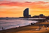 Sunset at Barceloneta Beach, In the background Hotel W, Barcelona, Catalonia, Spain.