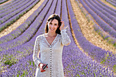 Young girl 30-35 years old, Cultivation of Lavender, Lavender in bloom, Valensole, Alpes-de-Haute-Provence, Provence-Alpes-Côte d'Azur, France, Europe
